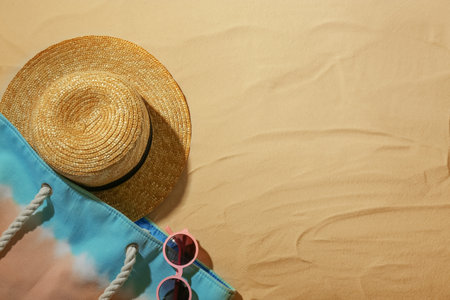 Beach accessories on sand, top view. Space for textの写真素材