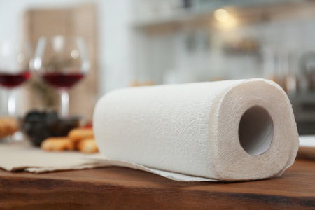 Roll of paper towels on table in kitchen, space for textの写真素材