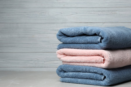 Stack of fresh towels on table. Space for textの写真素材