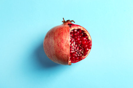 Ripe pomegranate on color background, top viewの写真素材