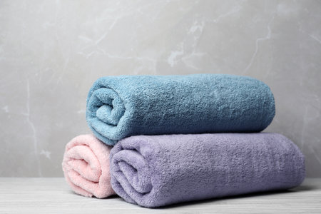 Pile of fresh rolled towels on tableの写真素材