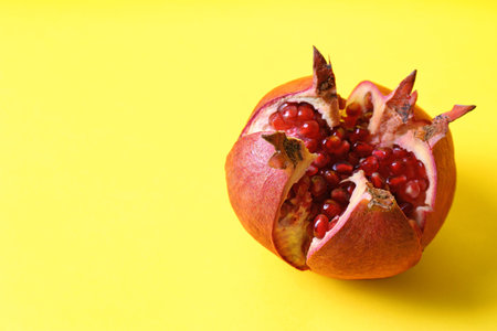 Ripe pomegranate on color background, space for textの写真素材