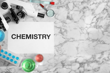 Flat lay composition with laboratory glassware, microscope and space for text on marble background. Chemistry conceptの写真素材