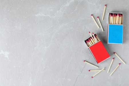 Flat lay composition with matches and space for text on light backgroundの写真素材