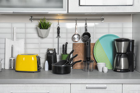 Set of cookware, clean dishes and appliances on kitchen counterの写真素材