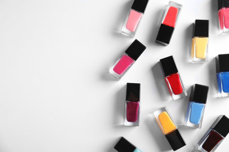 Bottles of bright nail polish on white background, top viewの写真素材