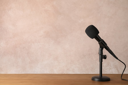 Modern microphone on table against color background. Space for textの写真素材