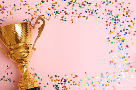 Trophy and frame of confetti on color background, top view with space for text. Victory conceptの写真素材