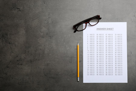 Flat lay composition with answer sheet and space for text on gray backgroundの写真素材