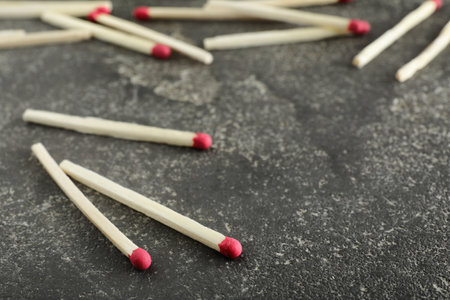 Scattered matches on gray background, space for textの写真素材