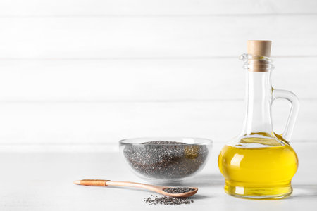 Composition with chia oil and seeds on table. Space for textの写真素材