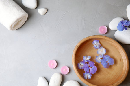 Flat lay composition with zen stones, spa bowl and towel on gray background. Space for textの写真素材