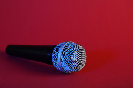 Modern microphone on color background. Space for textの写真素材