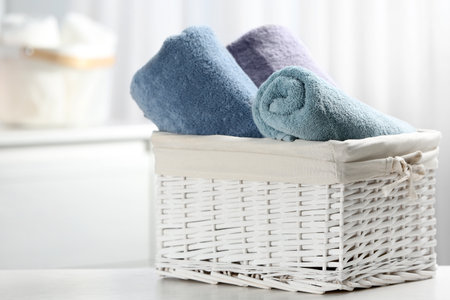 Basket of fresh towels on table. Space for textの写真素材