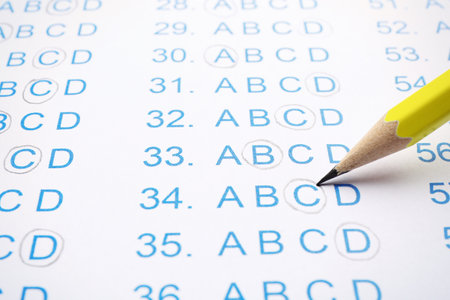 Filling answer sheet with pencil, closeup view