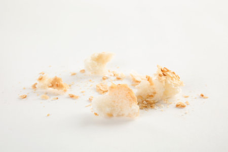 Scattered bread crumbs on white background, closeupの写真素材