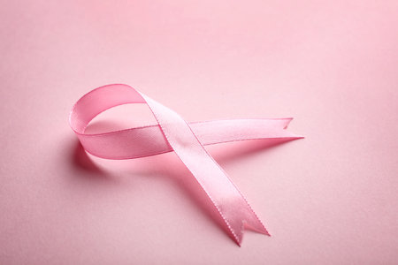 Pink ribbon on color background, space for text. breast cancer awareness conceptの写真素材