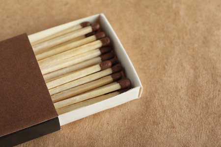Open box with matches on craft paper, space for textの写真素材