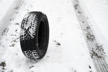 New winter tire on fresh snow. Space for textの写真素材