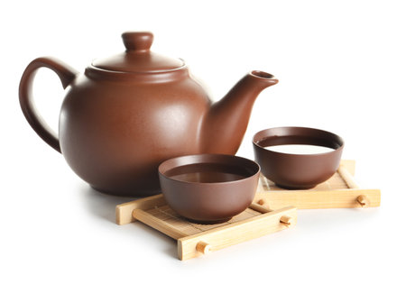 Cups and teapot of freshly brewed oolong on white backgroundの写真素材
