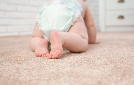 Cute little baby crawling on carpet indoors, closeupの写真素材