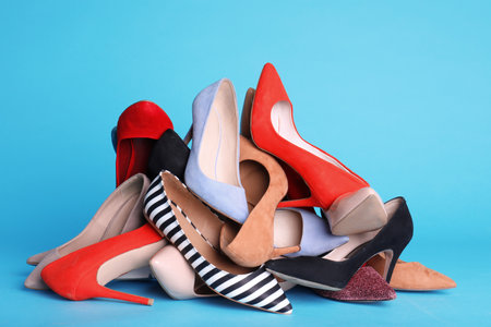 Heap of different shoes on color backgroundの写真素材