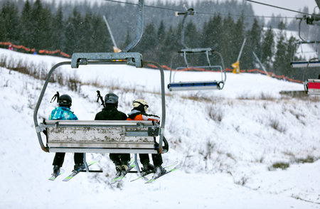 Chair lift with people at ski resort. winter holidaysの写真素材