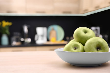 Fruit bowl with apples on table in kitchen, selective focusの写真素材