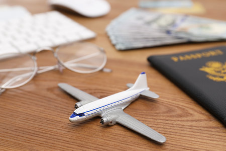 Airplane model and passport on table in travel agency, closeupの写真素材