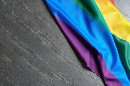Bright rainbow gay flag on table, top view with space for text. LGBT communityの写真素材