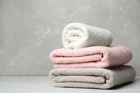 Stack of fresh towels on table. Space for textの写真素材