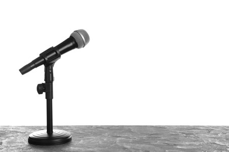 Modern microphone on table against white background. Space for textの写真素材
