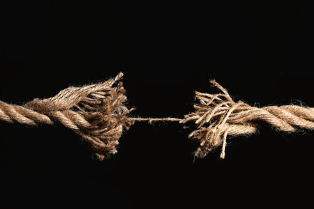 Rupture of cotton rope on black backgroundの写真素材