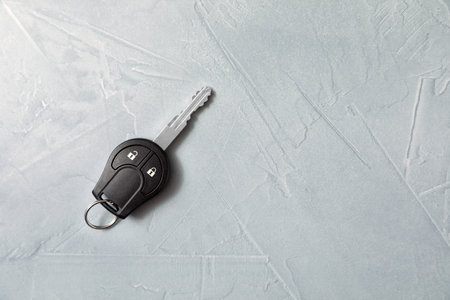 Car key on gray background, top view. Space for textの写真素材