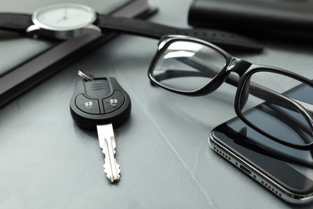 Composition with male accessories and car key on gray backgroundの写真素材