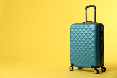 Stylish suitcase on color background. Space for textの写真素材