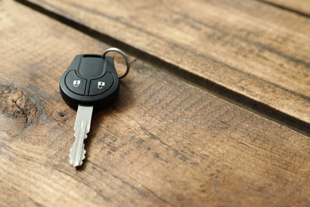 Car key on wooden background. Space for textの写真素材