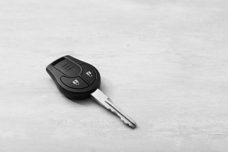 Car key on light background. Space for text
