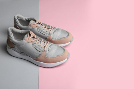 Pair of sports shoes on color background. Space for textの写真素材