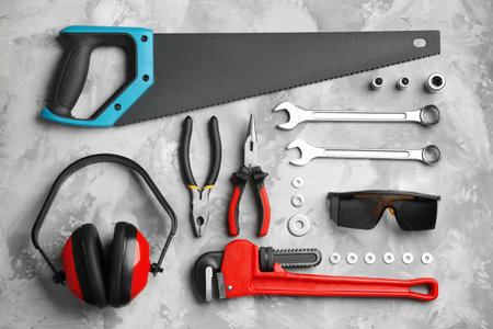 Flat lay composition with different construction tools on gray background
