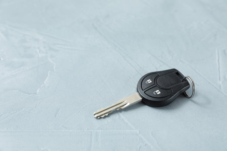 Car key on gray background. Space for textの写真素材