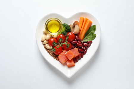 Plate with products for heart-healthy diet on white background, top viewの写真素材