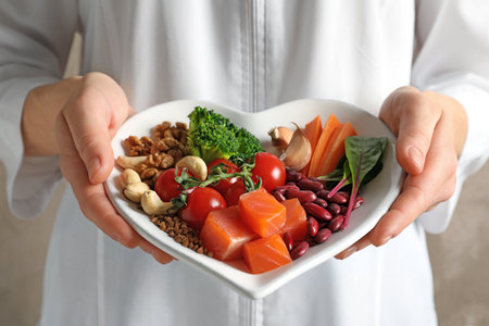 Doctor holding plate with products for heart-healthy diet, closeupの写真素材