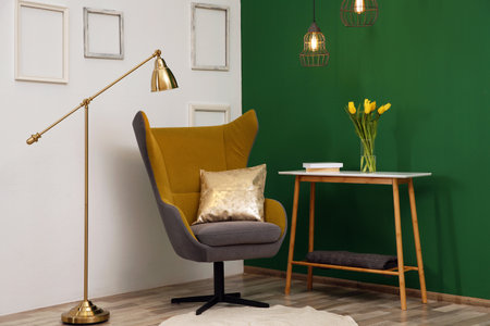Modern interior with comfortable armchair and table near color wallの写真素材