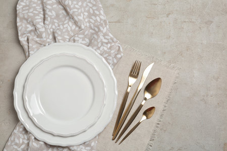 Stylish elegant table setting on light background, top view. Space for textの写真素材