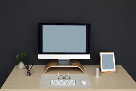 Modern workplace interior with computer on table. Space for text