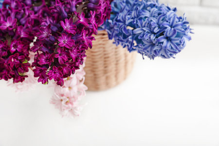 beautiful hyacinths in wicker pot on table, space for text. spring flowersの写真素材