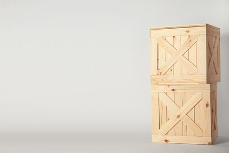 Wooden crates on light background, space for text. shipping containersの写真素材