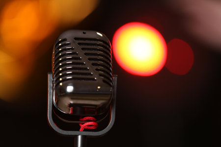 Retro microphone against festive lights, space for text. musical equipmentの写真素材