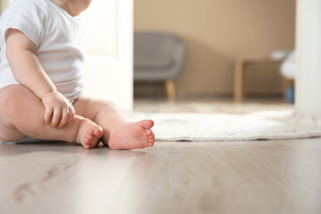 Cute little baby on floor indoors, closeup with space for text. Crawling timeの写真素材